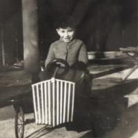 Tom driving a little car, 1941.