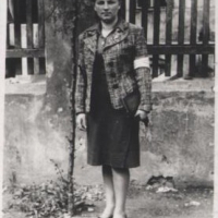Fanny, 1939, wearing her step-mother Yental Pasternack's clothes in order to look older for her work pass application. She has on a white armband with a Jewish star, which Jews in Poland were required to wear. 